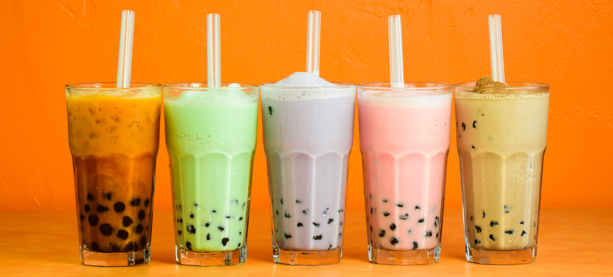 bubble tea drinks in glasses orange background